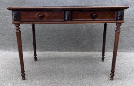 A 19thn century rosewood writing table with gilt tooled leather inset top, fitted with two frieze