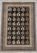 A contemporary hand made silk Baku rug with repeating stylised boteh motifs across the field