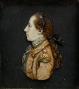 A Georgian carved wax profile portrait of a military officer in uniform, in a deep gold-leafed