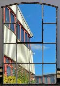 A large vintage iron framed industrial style window frame with panes fitted with mirror glass. H.183