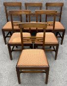 A set of six 19th century mahogany bar back dining chairs with needlework upholstered drop in seats.