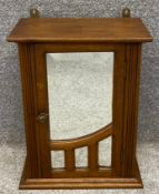 A late 19th century oak Art Nouveau style hanging cabinet with bevelled plate mirrored door. 49 x 38