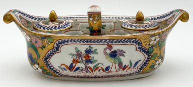 A 19th century hand decorated porcelain desk stand with twin lidded inkwells and fitted seal along