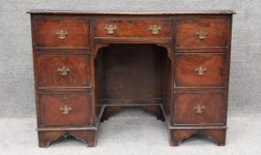 A Georgian style walnut kneehole desk. H.74.5 W.106 D.49.5cm