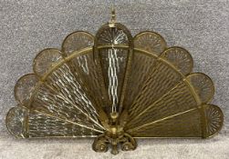 A vintage brass articulated peacock fire screen. H.61 W.95cm