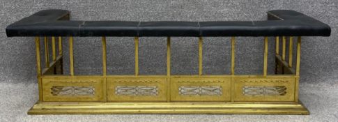 A 19th century brass club fender with leather upholstered seat. H.47 W.154 D.60cm.