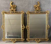 A pair of Italian gilt wall mirrors with hippocampus surmounts and naturalistic frames with bevelled