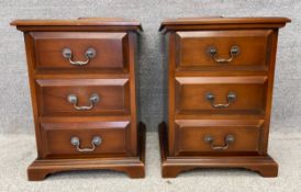 A pair of 19th century style bedside chests with simulated brass handles, raised on shaped bracket