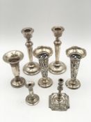 A pair of weighted silver candlesticks and a pair of pierced epergnes along with three other