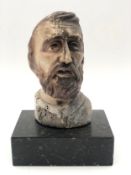 A carved head of a bearded man on a marble plinth base. H.20 W.13cm.