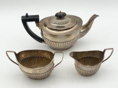A silver tea set comprising a teapot, cream jug, and a sugar bowl, all hallmarked Aldwinckle and