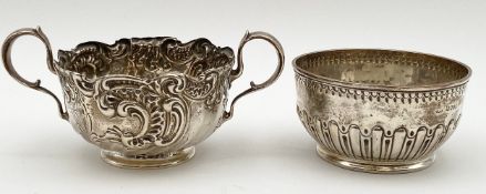 Two hallmarked silver bowls; one double handled with a baroque style foliate design, and the other a