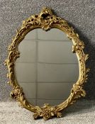 A contemporary gilt framed mirror in the Rococo style. H.63 W.46cm