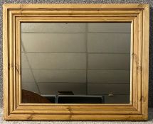 A contemporary pine framed mirror. H.62 W.76cm
