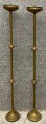 A pair of brass Gothic inspired floor standing candlesticks. H.113cm (largest).