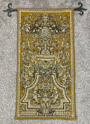 An Aubusson style linen backed wall hanging needlework tapestry with heraldic motifs and a cast iron
