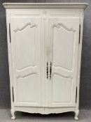 A 19th century French Provincial armoire, painted and with squat carved cabriole supports. H.207 W.