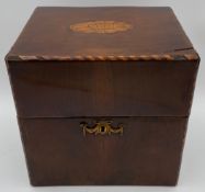 A Georgian mahogany decanter box with satinwood inlay and a marquetry conch shell motif to the