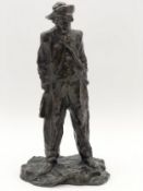 After Edouard Fortini, a patinated bronze figure of a standing man, signed to base with foundry