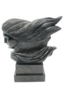 A carved black marble bust of a classical style goddess in flight. H.29 W.25cm.