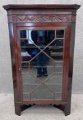 A 19th century carved walnut hanging corner cabinet with astragal glazed door. H.144 W.89 D.48cm