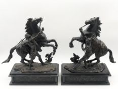 After Guillaume Coustou, a pair of patinated bronze Marly horse figure groups. H.35 W.30cm.