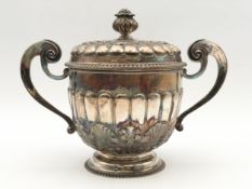 A silver twin handled lidded urn with all over embossed foliate decoration, marked Holland
