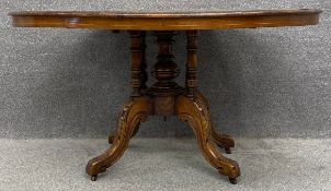 A 19th century tilt top dining table, quarter veneered in walnut, crossbanded with a central