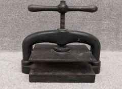 A cast iron book press. H.38 W.43 D.25cm