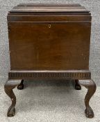 A Georgian oak two section wine cooler, the hinged lidded top on base with cabriole supports. H.75