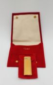 A Cartier gilt metal lighter in Cartier case. H.8cm