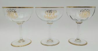 Three crystal champagne coups with gilt decoration. H.17 Dia.13cm