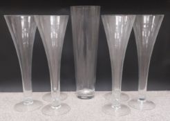 A set of six large glass florist's lily vases, along with one other taller vase. H.64 (6 x vases)