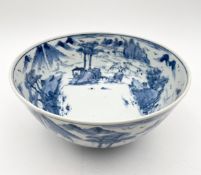 A 19th century blue and white bowl painted with continuous landscapes bearing marks to the