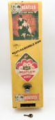 A mid century yellow painted A&BC The Beatles themed dispenser/vending machine, covered in various