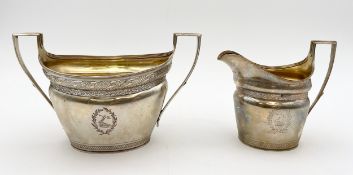 A silver sugar bowl and cream jug, the jug with London marks (rubbed), the sugar bowl unmarked but