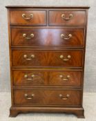 A Georgian style flame mahogany two short over four long chest of drawers, with satinwood inlay,