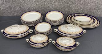 A Wedgwood part dinner service with a blue glaze and gilt Regency style motifs, comprising four