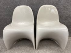 A pair of mid-century white moulded plastic Panton chairs by Herman Miller, with maker's marks. H.