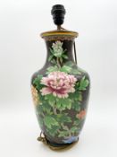 A Chinese cloisonne vase lamp with a blossom design on a black ground, with labels to the base. H.