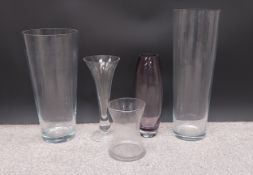 Five various florist's vases, one with a purple colouring. H.65cm (Tallest)