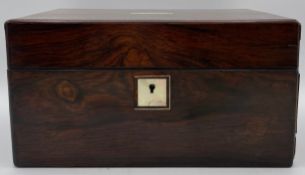 An early 19th century rosewood vanity box with mother of pearl inlay and a velvet lined interior