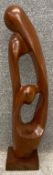A mid century carved teak abstract figural figure group sculpture.. H.76cm.