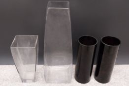 A collection of four glass florist's vases to include two of cylindrical form and two square and