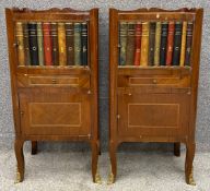 A pair of Louis XV style kingwood cabinets with faux book spine panel doors above drawers and