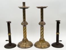 A pair of 19th century brass ecclesiastic candlesticks and a pair of 18th century brass and iron