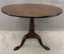 A Georgian Cuban mahogany tripod table on pad feet with a tilt top action. H.73 Dia.90cm