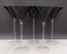 A set of five large dark glass martini glass florist's vases. H.50 Dia.26cm