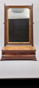 A Georgian mahogany toilet mirror with a crossbanded and featherbanded top, the plate being framed