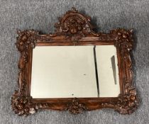 A 19th century style wall mirror in ornate moulded frame. H.33 W.77cm